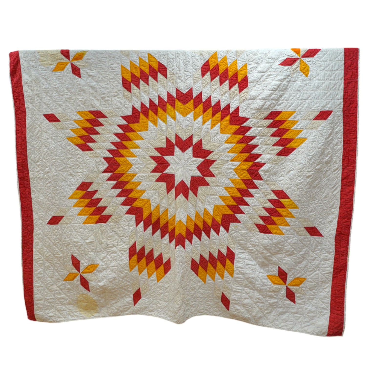 A late 19th century / early 20th century American ‘Star of Bethlehem’ quilt, worked on a plain light cream ground with red and yellow and beige patchworks forming a large double line star with a simple single red inner l